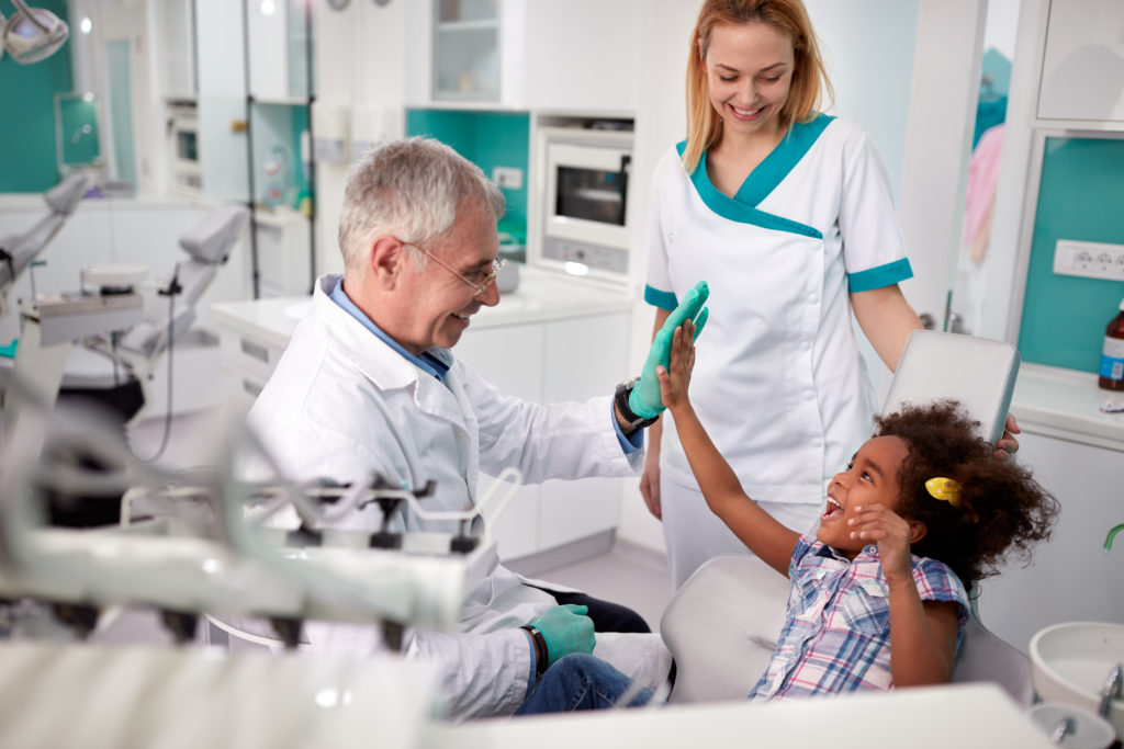 A woman and child at a general dentist's office near you