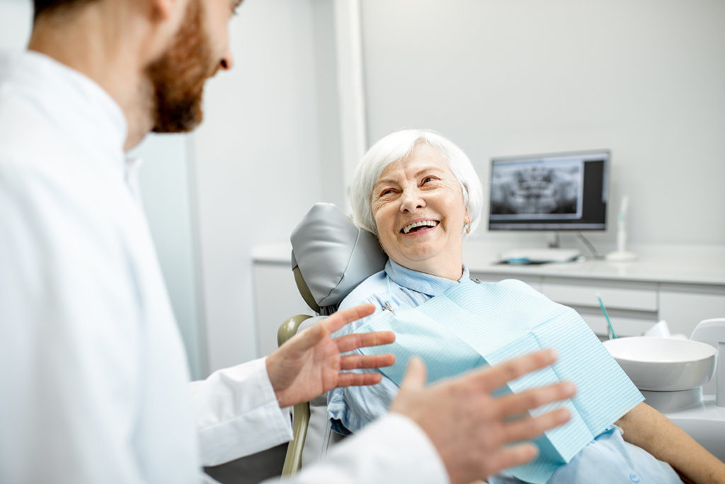 old woman happy after dental implant treatment in vancouver